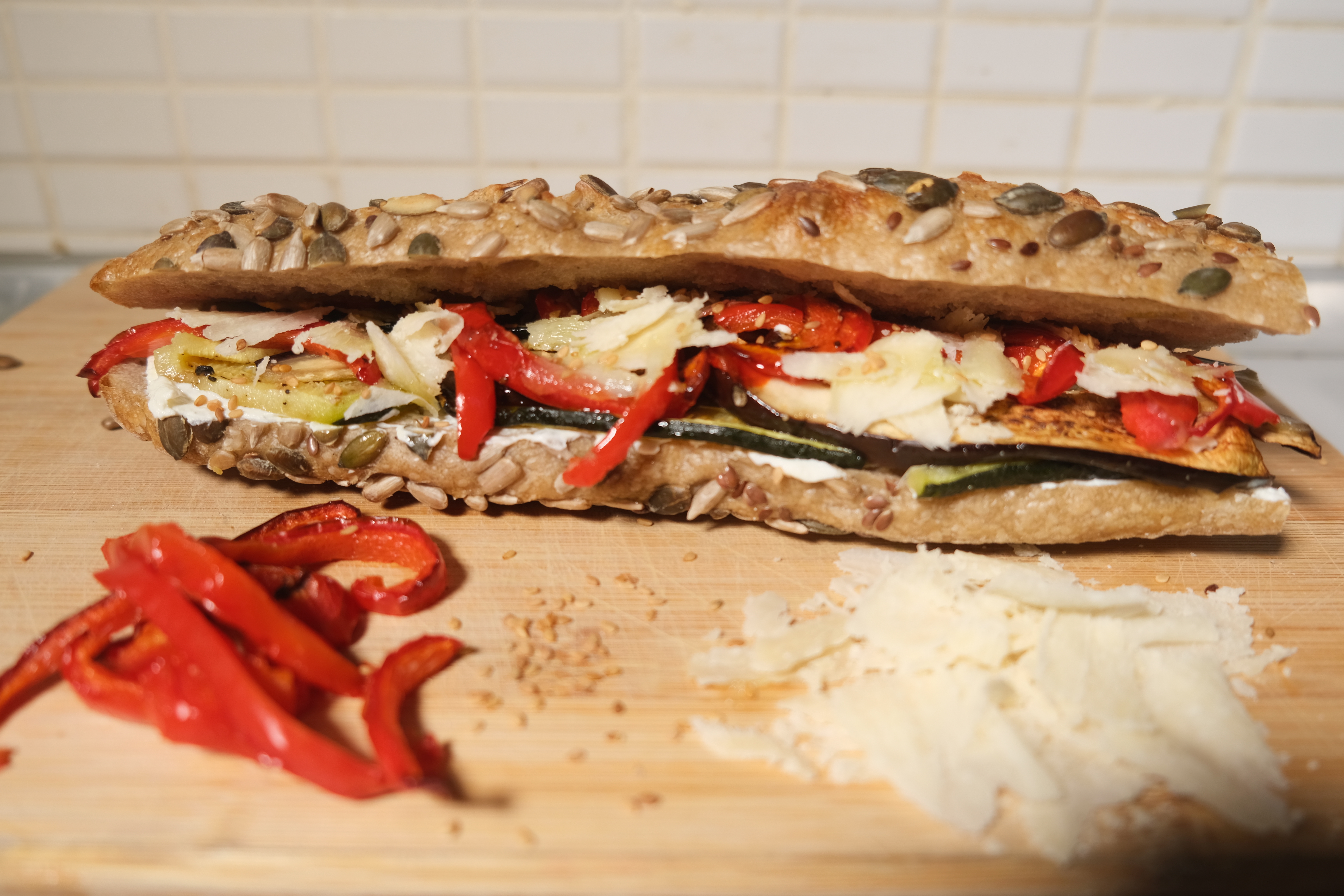 Veggie sandwich with fresh vegetables, hummus and mixed greens on baguette